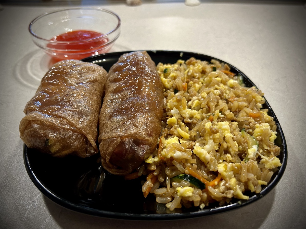 Plate of spring rolls and fried rice