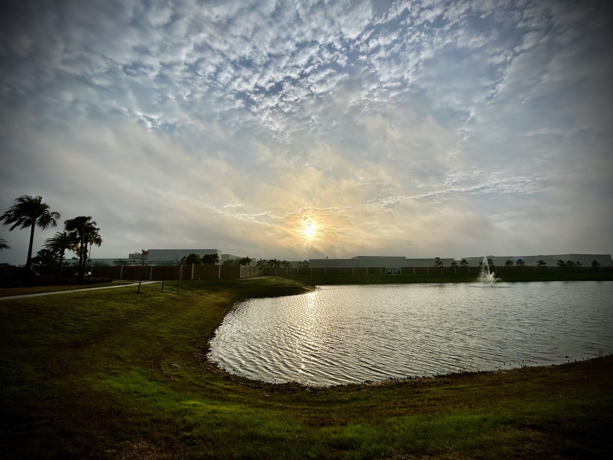 Sunrise over a build and pond