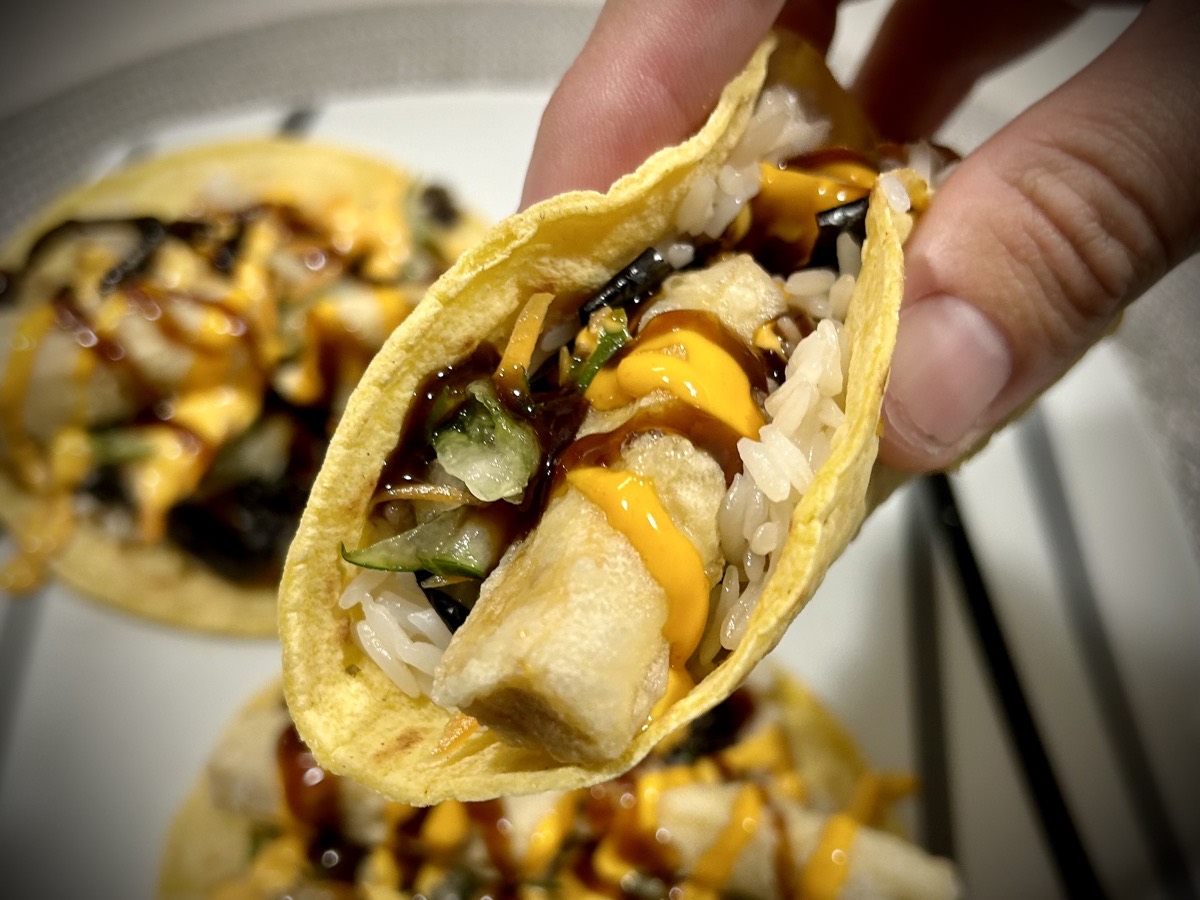 Close up of a tofu tempura taco in hand