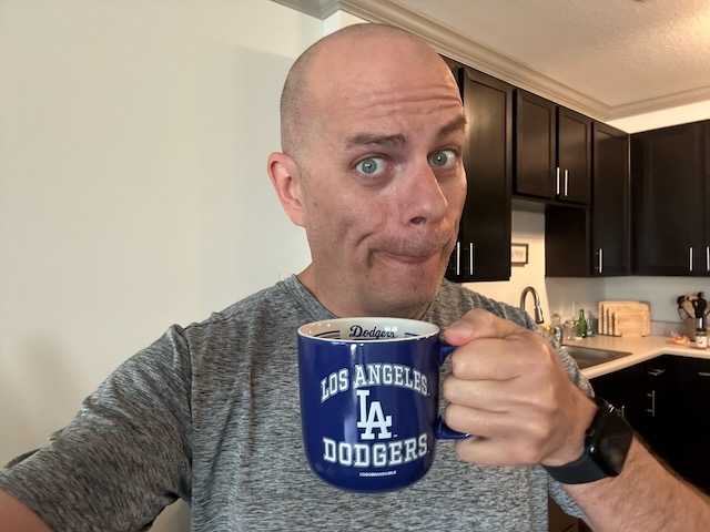 Selfie with a goofy face while holding a coffee mug
