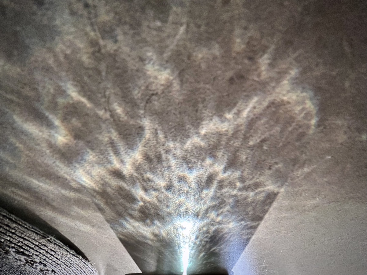 Sunlight reflecting on a surface through a glass of water.