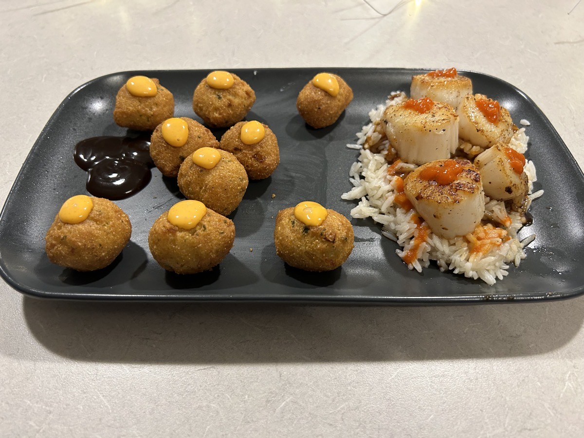 Plate of scallops, rice, and hush puppies