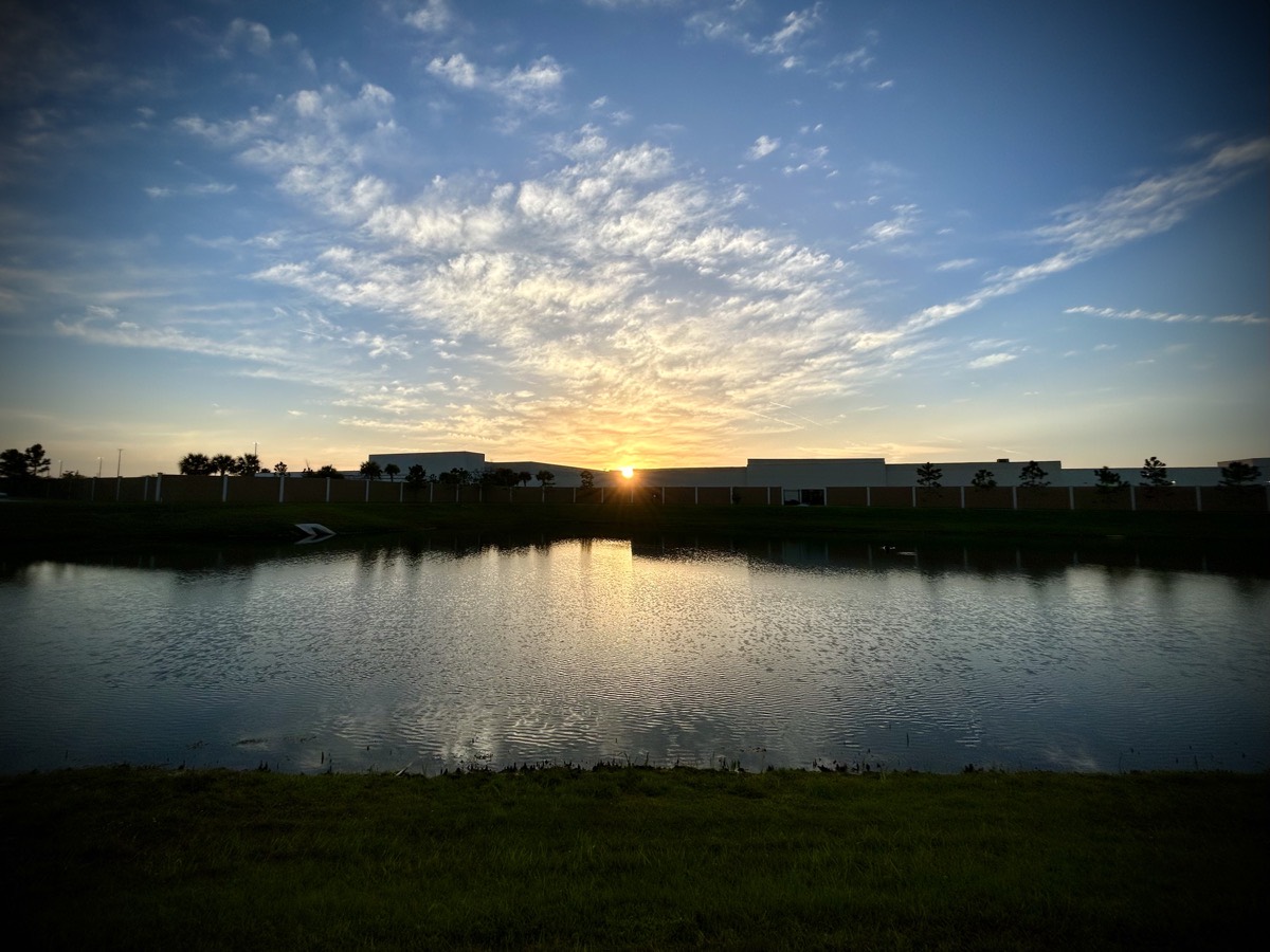 Sunrise over a build and pond
