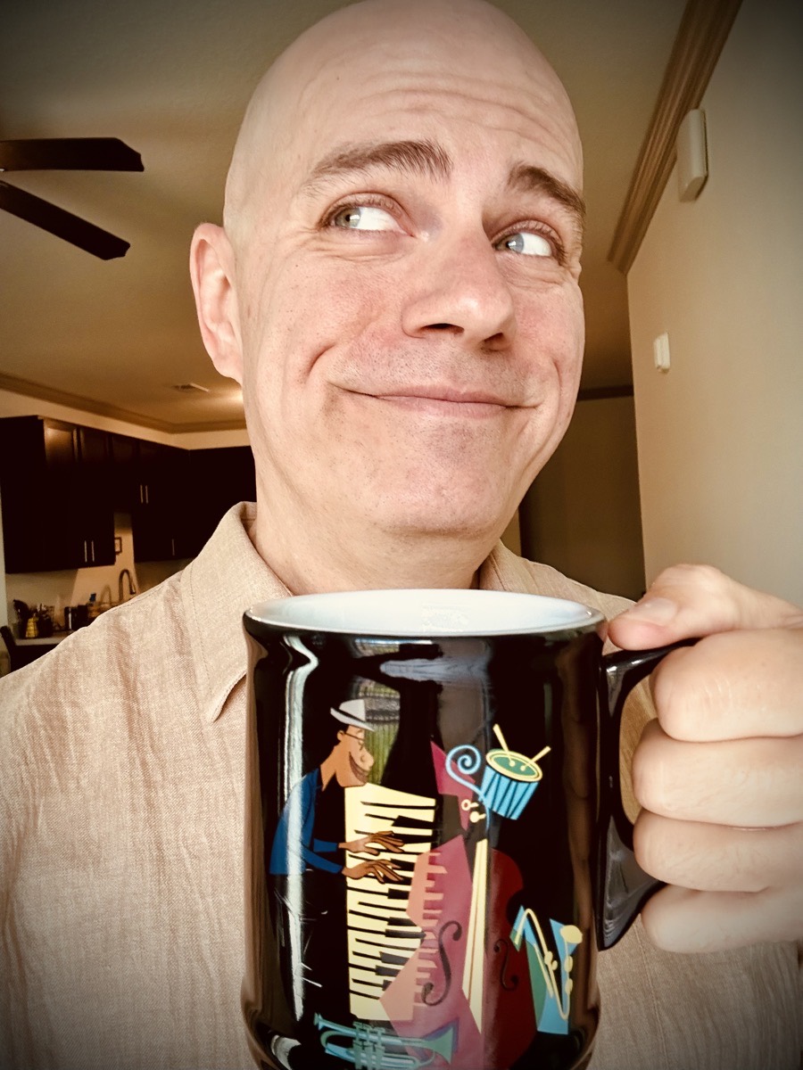 Selfie with a coffee mug from the movie Soul with jazz instruments on it